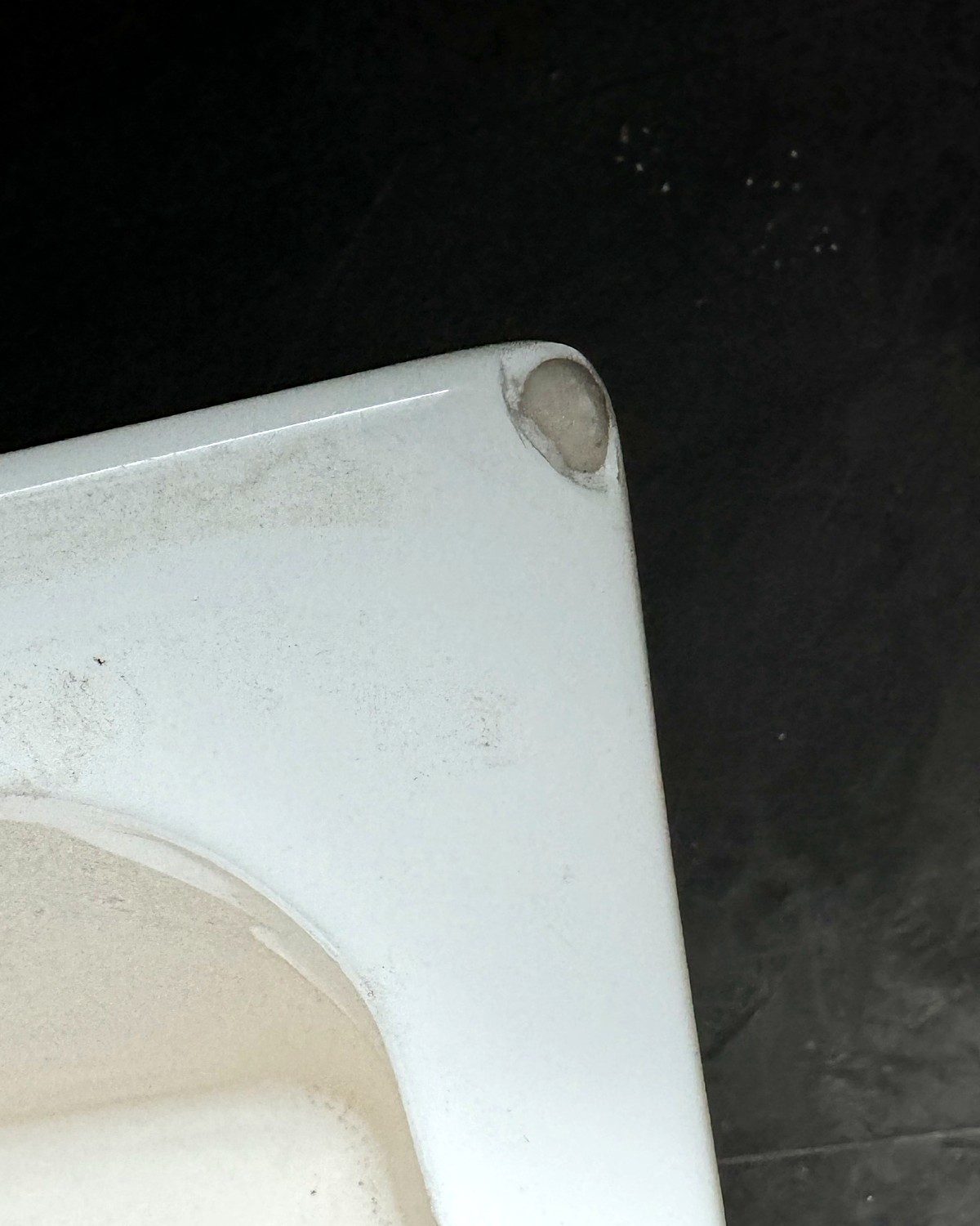 Before: chipped corner on a new bathtub