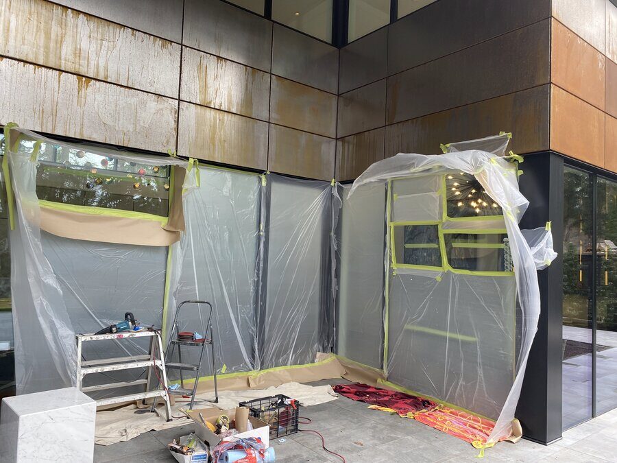Protective sheeting and tools set up around a run of windows